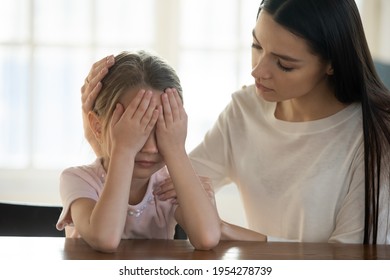 Caring Young Caucasian Mother Comfort Caress Upset Sad Little Daughter Having Bullying Problems At School. Loving Mom Support Unhappy Small Girl Child Crying Feeling Bad. Family Trouble Concept.