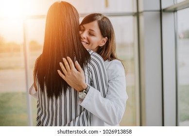 Caring Young Medical Doctor Hugging Patient.