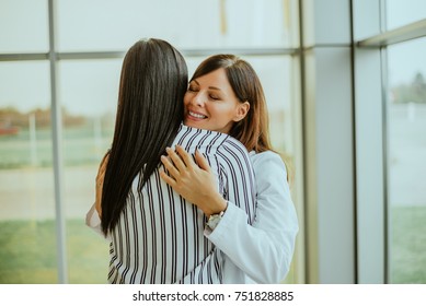 Caring Young Medical Doctor Hugging Patient.