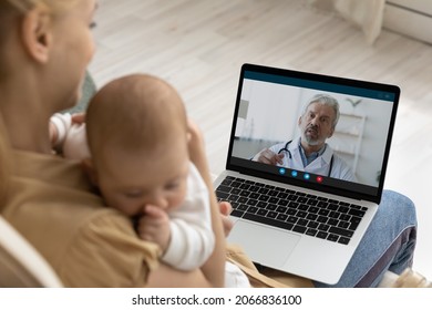 Caring young mother holding sleeping baby, using laptop, making video call to mature man doctor at home, senior pediatrician consulting loving mom online, telemedicine and child healthcare concept