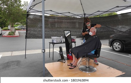 Carlsbad, CA / USA - August 24, 2020: An Older Man Is Getting A Haircut Outside As Sports Clips Hair Salon Moved Operations Outdoors To Avoid Covid-19 Shutdown.                               