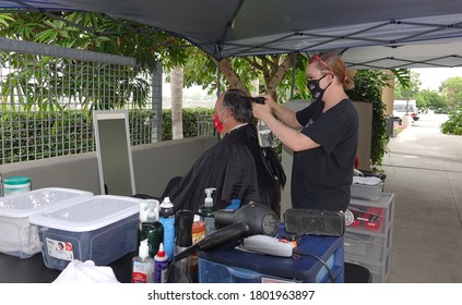 Carlsbad, CA / USA - August 24, 2020: An Older Man Is Getting A Haircut Outside As Sports Clips Hair Salon Moved Operations Outdoors To Avoid Covid-19 Shutdown.                               