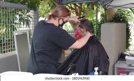 Carlsbad, CA / USA - August 24, 2020: An Older Man Is Getting A Haircut Outside As Sports Clips Hair Salon Moved Operations Outdoors To Avoid Covid-19 Shutdown.                               