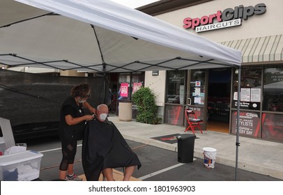 Carlsbad, CA / USA - August 24, 2020: An Older Man Is Getting A Haircut Outside As Sports Clips Hair Salon Moved Operations Outdoors To Avoid Covid-19 Shutdown.                               