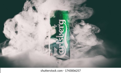 Carlsberg beer can toned photo with smoke. Carlsberg is popular Danish pale lager with a global distribution. MINSK, BELARUS, May 27, 2020.