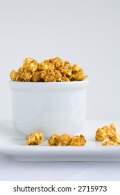 Carmel Covered Popcorn In A White Bowl Overflowing