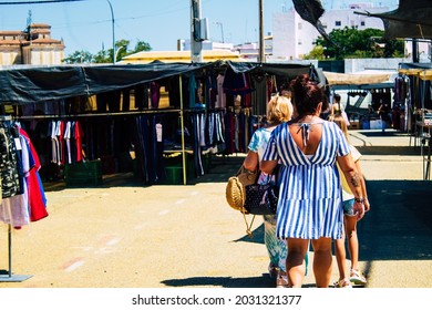 Carmona, Spain August 9, 2021 A Grandmother, A Mother And A Child Back Turned Walking And Wearing Masks In Mandatory In A Local Market Set Up Every Monday During The Coronavirus Outbreak