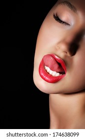 Carnality. Lust. Provocative Woman Licking Her Red Sexy Lips. Passion