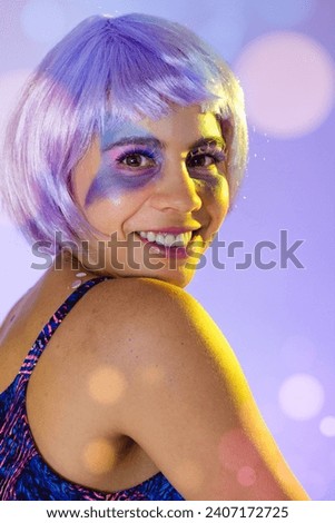 Carnaval Brazil. Excited and Cheerful. Colorful background. Carnival concept, fun and party. Portrait of latin woman wearing purple wig and makeup mask.