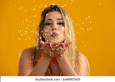 Carnaval Party. Brazilian Blonde Hair Woman In Costume Blowing Confetti.