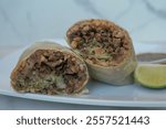 carne asada burrito on a white marble background