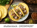 carnitas tacos with salsa and lime