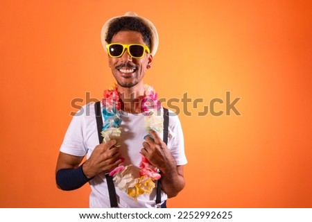 Carnival Brazilian Outfit. Black Man With Carnival Costume Having Fun,  Isolated on Orange Background
