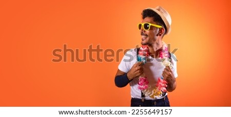 Carnival Brazilian Outfit. Black Man With Carnival Costume Having Fun,  Isolated on Orange Background