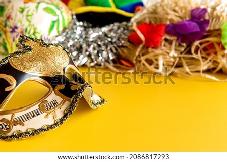 Carnival concept on yellow background, Brazilian carnival mask.
