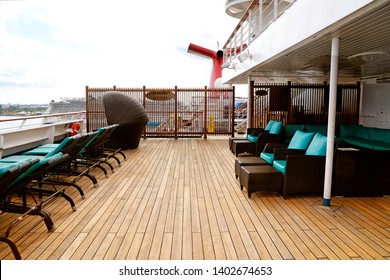 Carnival Cruise Line Open Deck With Chaise-longues Asnd Seats For Rest And 
Carnival Cruise Funnel At The Back.  Miami, Florida. May 12, 2019