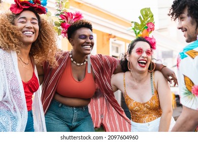 Carnival day in Brazil, woman and friends dance at street party. People in costumes celebrate Brazilian Carnaval