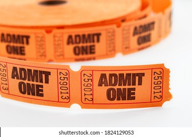 Carnival draw winner, admit one ticket and movie theater admission concept with close up on orange color roll of raffle tickets