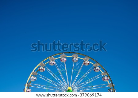 Carnival Ferris Wheel with Clean Skies with Empty Space
Close up shot of half of a ferris wheel in Coachella California.