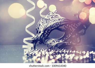 Carnival mask with glittering background. - Shutterstock ID 1009614340