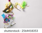 Carnival masks with party horns and decor for Mardi Gras celebration on white background