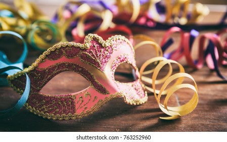 Carnival Party. Mask And Serpentines On Wooden Background, Front View