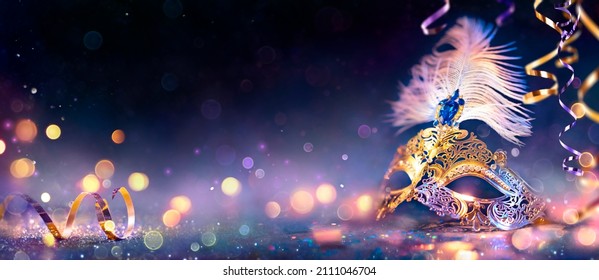 Carnival Party - Venetian Mask With Abstract Defocused Bokeh Lights And Shiny Streamers - Masquerade Disguise Concept - Powered by Shutterstock