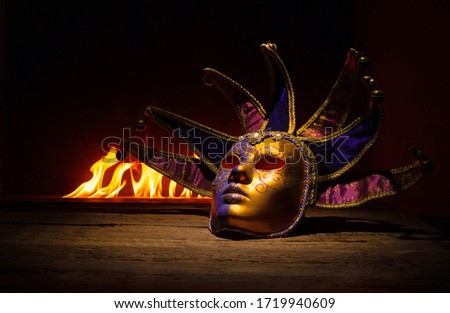 Carnival venetian mask against the fire