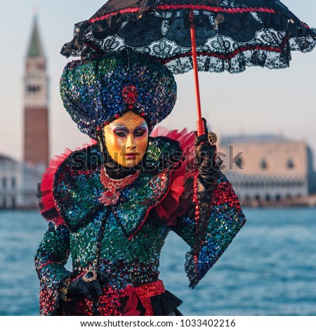 Carnival of Venice, beautiful mask at St. George island with Mark's Square in the background.