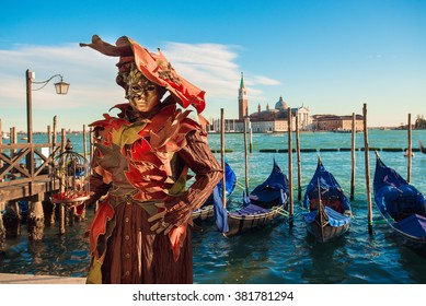 Carnival Of Venice Man In Mask And Gondola. Grand Canal