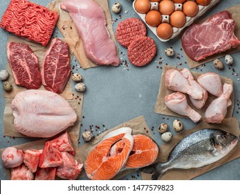 Carnivore diet concept. Raw ingredients for zero carb diet - meat, poultry, fish, seafood, eggs, beef bones for bone broth and copy space in center on gray stone background. Top view or flat lay. - Shutterstock ID 1477579823