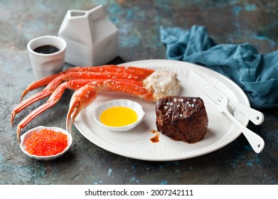 Carnivore-Ketogenic Diet Lunch Or Dinner. Filet Mignon Steak, Butter Sauce, Crab Legs And Red Caviar, Selective Focus.