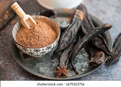Carob powder and pods in a plate