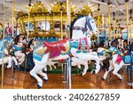 Carousel in amusement park. Horses on a traditional fairground vintage carousel.