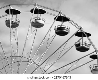 Carousel Ferris wheel with colorful cabins. Fun fair attractions. A carousel gondola isolated against a blue sky. Ferris wheel carousel design.