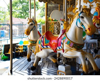 Carousel horses in the amusement park, old carousel with many colored toys for all ages of children at an amusement fair. - Powered by Shutterstock