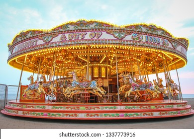 Carousel with warm lights during a summer evening near the sea