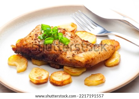 carp on cumin with fried potatoes