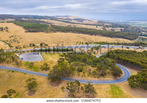 A carpark and road system\
running through large green farmland south of Adelaide in\
Australia
