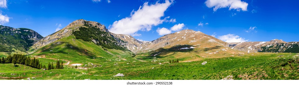 Carpathian Mountains Range, Romania. Amazing cloudy summer scenery with Bucegi Mountains and Ialomita Valley, ridge by dolomite rocks, most famous for hiking tourists.