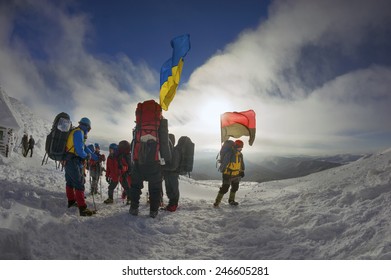 Carpathian Mountains, Ukraine-January 8, 2015: Climbing The Christmas Ukrainian Climbers On The Top Of The Main Country With The State  The Flag And The Rebel Army Roman Shukhevych And Stepan Bandera