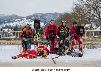 Carpathians, UKRAINE - JANUARY 08, 2017: A Group Photo Of Children Carol Singers Dressed Up In Traditional Christmas Masks And Clothes Standing In The Road In Winter In A Small Carpathian Village