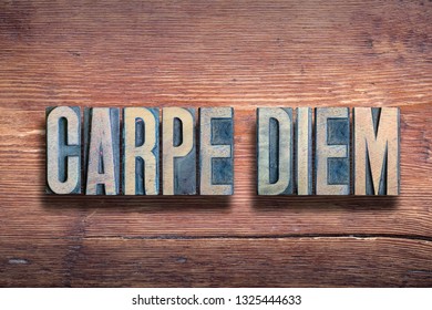 carpe diem - famous ancient Roman poet Horace quote with meaning - seize the day, made from wooden letterpress type on grunge wood - Shutterstock ID 1325444633
