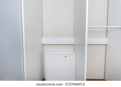 A carpenter assembling a wardrobe in a vestibule, a precise handiwork.