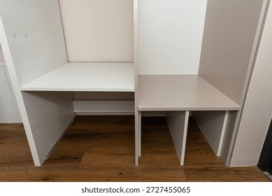 A carpenter assembling a wardrobe in a vestibule, a precise handiwork.