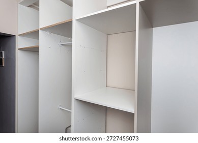 A carpenter assembling a wardrobe in a vestibule, a precise handiwork.