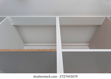 A carpenter assembling a wardrobe in a vestibule, a precise handiwork.