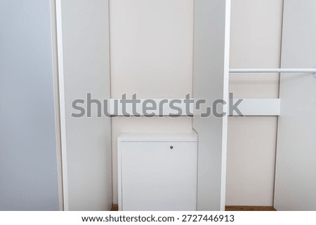 A carpenter assembling a wardrobe in a vestibule, a precise handiwork.