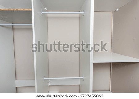A carpenter assembling a wardrobe in a vestibule, a precise handiwork.