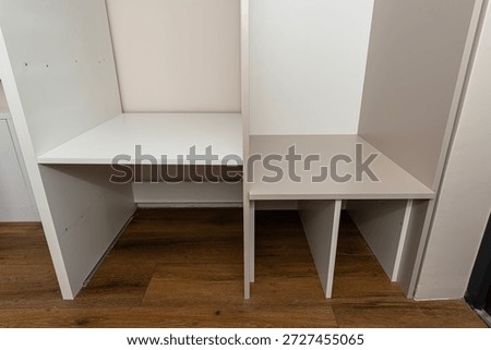 A carpenter assembling a wardrobe in a vestibule, a precise handiwork.